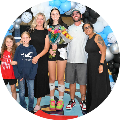 Athlete posing with family members during a celebration